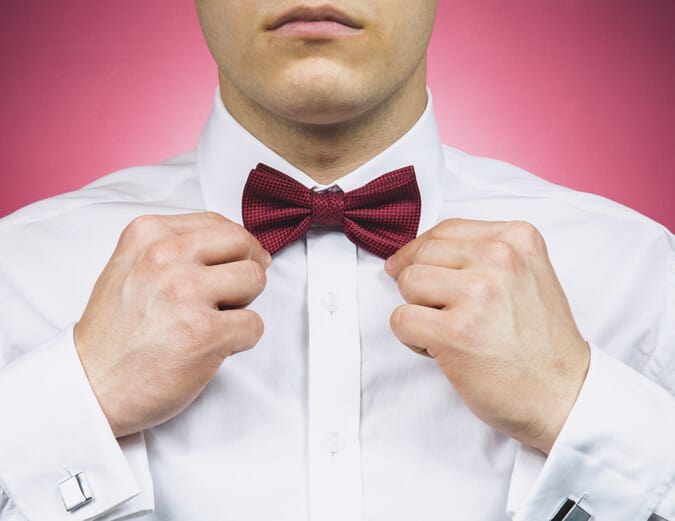 Man adjusting a bow tie