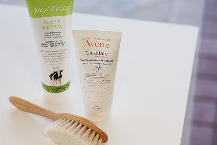 Image of Cradle Cap treatment products Avene Cicalfate, MooGoo Scalp Cream and baby brush