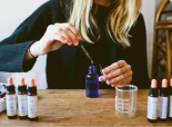 lady using eye dropper into product bottles